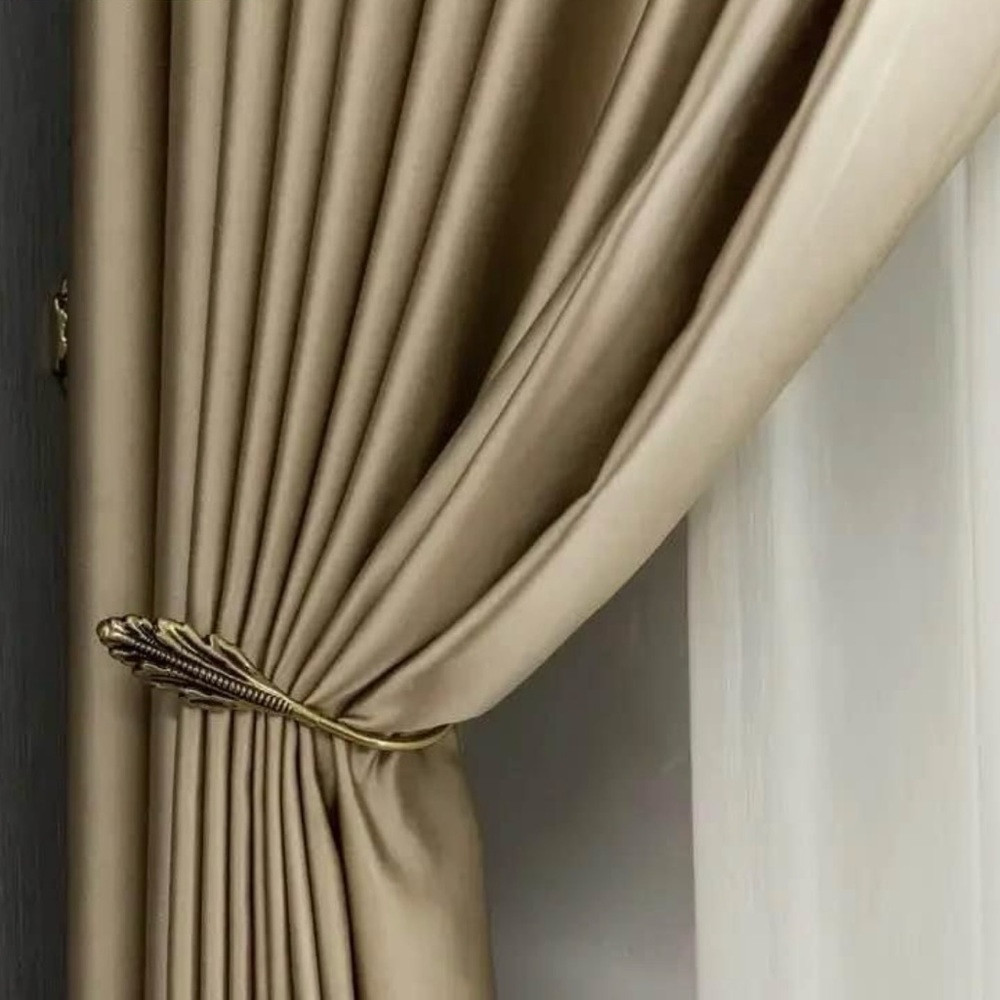 A pair of light gold/champagne blackout curtains